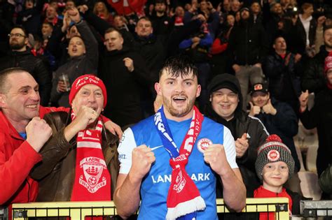 Larne fans celebrate historic football win .